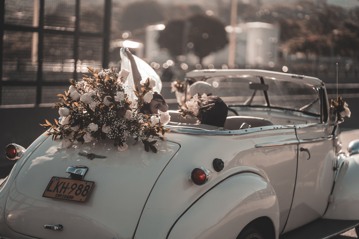 Vintage cabriolet decorated with white wedding flowers